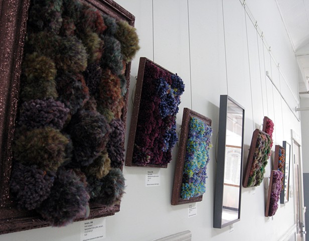 sculpture installation old redmond school house brown glittered picture frames and multicolored yarn pom poms by Holly Campbell