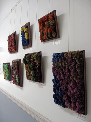 sculpture installation of brown glittered picture frames and multicolored yarn pom poms old redmond school house by Holly Campbell