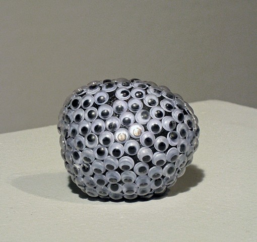 found rock sculpture covered in wiggly eyes by Holly Campbell