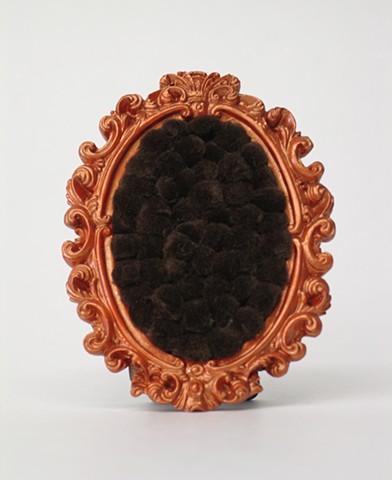 found picture frame sculptures painted pearly orange filled with brown colored pom poms by Holly Campbell