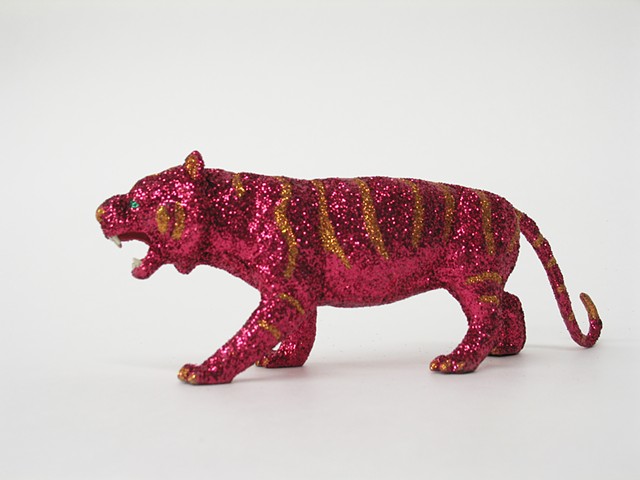 toy tiger covered in magenta and orange glitter by Holly Campbell