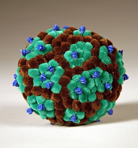 found rock covered in green turquoise and brown fuzzy pom poms and plastic policemen toy heads by Holly Campbell