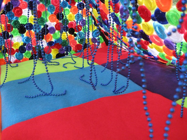 tent sculpture with rainbow pipe cleaners, felt and blue strung beads by Holly Campbell