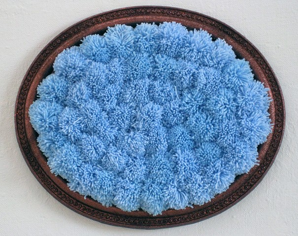 large brown glittered ready-made picture frame filled with sky blue yarn pom-poms by Holly Campbell
