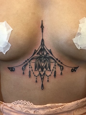 Delicate sternum chandelier tattoo