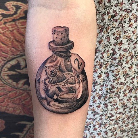 Frog in a bottle tattoo