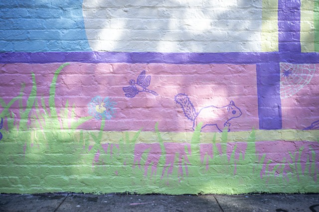 detail of squirrel, dragonfly, bee, and spider in dappled sunlight