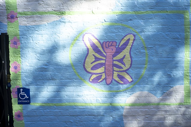 detail of butterfly with a fist in dappled sunlight