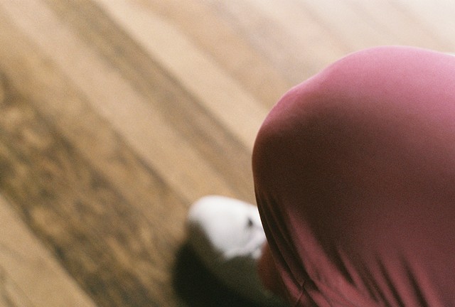 Salmon-coloured pants, white shoes, and hardwood floors