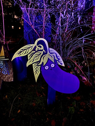 2021 Fall Witches Display lit at night. Displayed at the blue house on the corner of Kidder St. and Powder House Terrace, October - November
