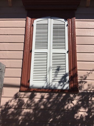 Custom-made shutters with curved top for historic New Orleans building. Designed to meet Historic District requirements.