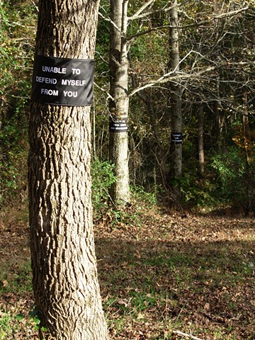 environmental tree wraps, made of fabric and paint, displayed in woods by Rebecca Stuckey