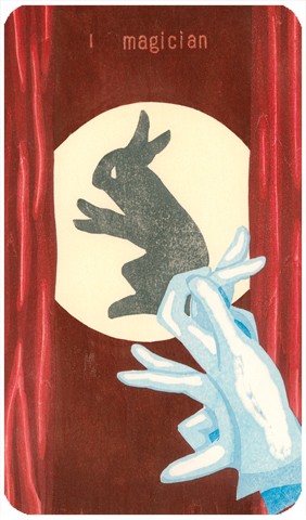 The Magician Tarot card: two gloved hands make a hand shadow puppet of a rabbit on a wall behind red curtains.