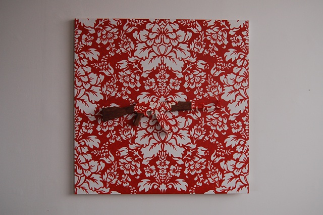 artwork consisting of wood, paint, ceramic, underglaze, glaze. ceramic AK/47 victorian wallpaper pattern red & white.