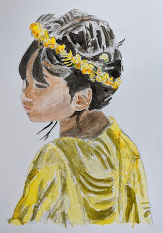 Portrait of a young girl in a yellow dress with a yellow flowered headband