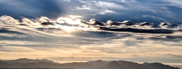 Wave shapes clouds over Denver