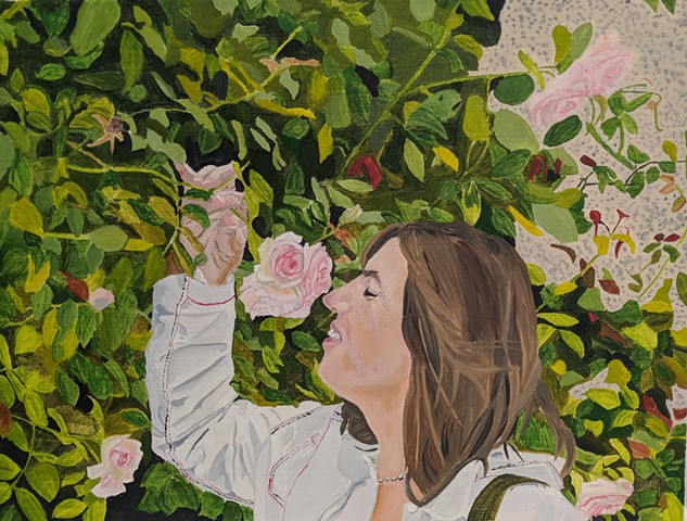 Portrait of woman smelling roses