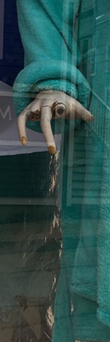 Mannequin hand broken missing fingers in a storefront window