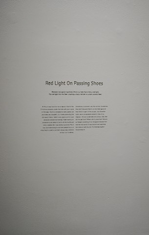 Red Light On Passing Shoes is a story engraved into the gallery wall. The story is of an insulation done a month prior to the show.