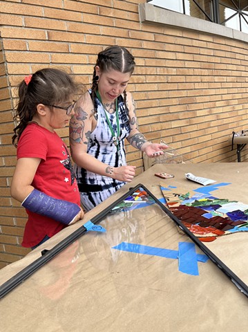 Rachel and youth adhering glass