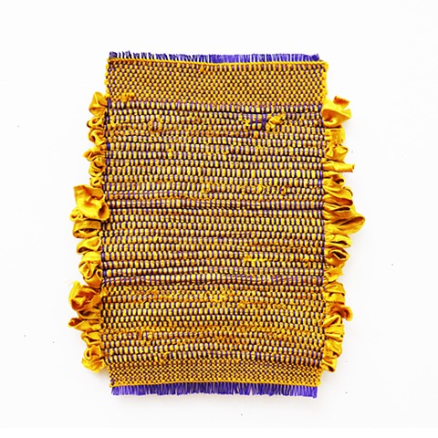 a 16” x 20” purple warp and gold recycled skirt woven textile