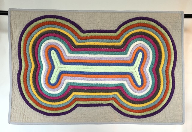 Wall hanging. Floor mat. Machine-stitched commercial cotton fabric. Dog bone wall-hanging.