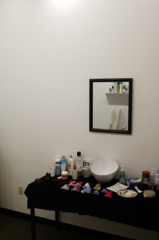 An installation featuring plastic noses stylized as health & wellness appliances, advertising a better you.