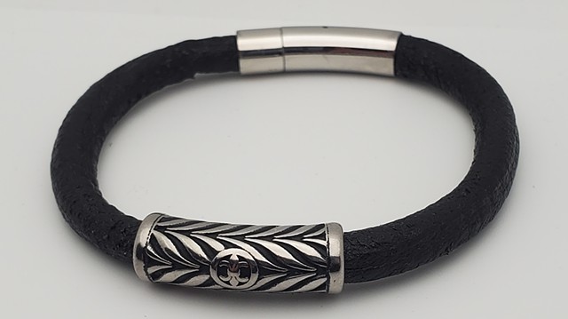 The handmade men's heavy duty leather bracelet with stainless steel with stainless steel magnetic locking clasp is a bracelet made for a lifetime of use and abuse. Each bracelet comes in a unique and funky graffiti-inspired vinyl casing featuring 15th cen