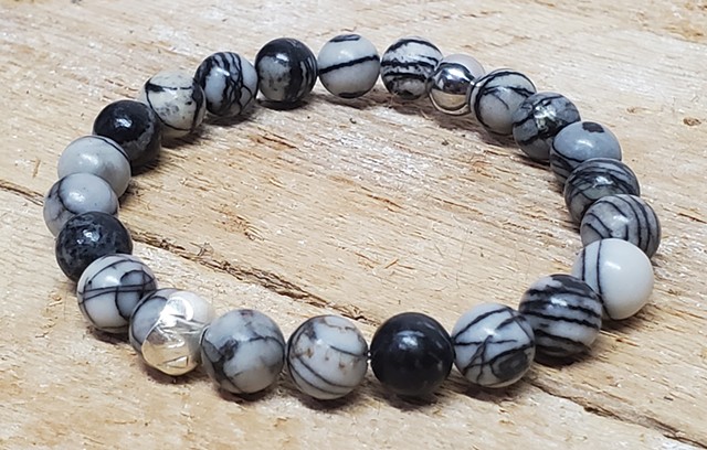 Black Silk Stone Bracelet Matte Black Stone 8mm Beaded Stretch Grounding Healing Bracelet with Red Gemstone. Handmade unisex stretch bracelet for men or women made with 8mm black and white silk stone beads, with a stainless steel bead . Black stones offer