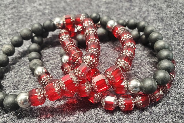 Handmade unisex stretch bracelet made with Red or Blue Czech Glass beads with 8mm matte black stone beads. Healing yoga chakra bracelet. Black stones offer purity, protection, and grounding qualities through the root chakra. Our bracelets are made to last