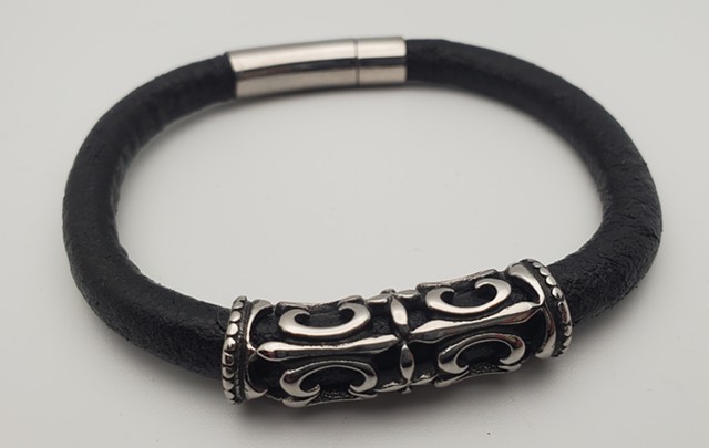 The handmade men's heavy duty leather bracelet with stainless steel with stainless steel magnetic locking clasp is a bracelet made for a lifetime of use and abuse. Each bracelet comes in a unique and funky graffiti-inspired vinyl casing featuring 15th cen