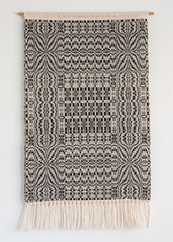 Black and cream intricate wall hanging in traditional overshot.