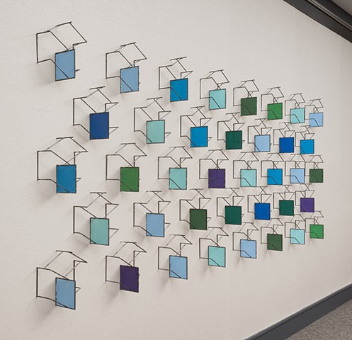 Wall sculpture in 38 parts.  Piece is designed to be modular and fit a variety of spaces.p