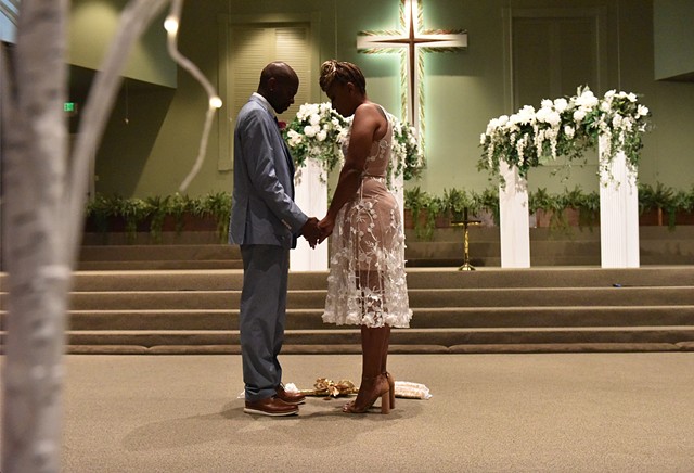Terrence John Teat and Kimberly Cawanna Shannon get married as part of a mass wedding during Juneteenth celebrations at New Horizon Church in Jackson, Miss., Saturday, June 18, 2022.