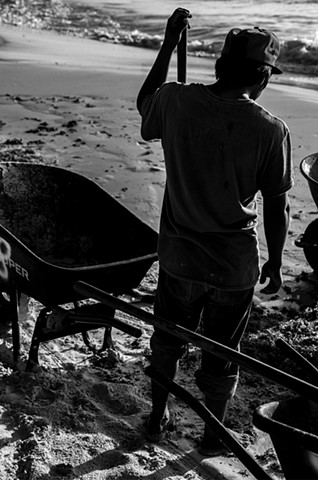 These young men use rakes, wheelbarrows, and little else; this part of the beach isn't accessible by tractor, so everything is done slowly and manually. 