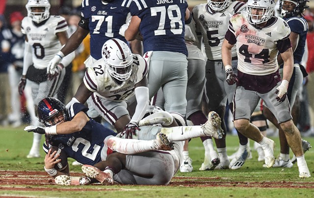 Ole Miss QB Jaxson Dart (2) is tackled by Mississippi State DT Nathan Pickering (22) at the 2022 Egg Bowl at Ole Miss' Vaught-Hemingway Stadium in Oxford, Miss., Thursday, November 24, 2022. Mississippi State beat Ole Miss with a final score of 24-22.