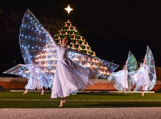 Dancers dressed as angels perform in front of the Belhaven Concert Choir at Jackson’s annual Singing Christmas Tree at Belhaven’s Bowl Stadium in Jackson, Miss., Friday, December 2, 2022.