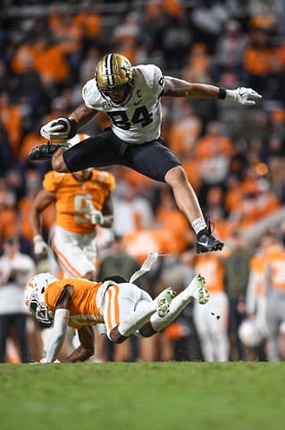 Vanderbilt WR Kaleb Webb (84) jumps over Tennessee defensive back Doneiko Slaughter (0) during the game against Tennessee at Neyland Stadium in Knoxville, Saturday, Nov. 25, 2023.