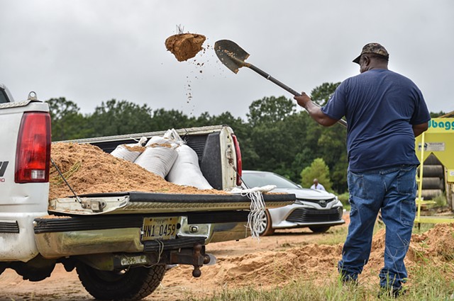 Local resident Sidney Cary shoveled his own sand straight into his truck to assist with flooding at City of Jackson Public Works in Jackson, Miss., Friday, August 26, 2022.