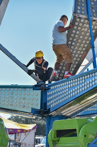 Fair workers put finishing touches on the rides on the opening day of the Mississippi State Fair at the State Fairgrounds in Jackson, Miss., Thursday, October 6, 2022.