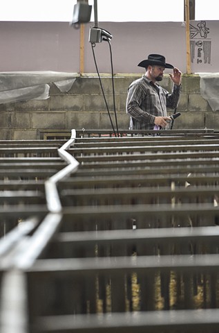Mark Wolken cleans stalls ahead of his 8th time showing his goats at the Dixie National Rodeo at the State Fairgrounds in Jackson, Miss., Wednesday, Feb. 8, 2023.