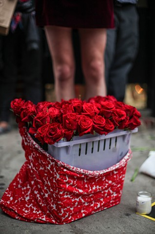 A bucket of red roses sits amongst candles and flowers at a rally in remembrance of the victims of the Orlando nightclub shootings at The Stonewall Inn in New York on June 12, 2016.