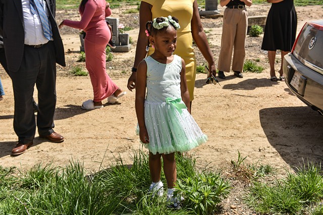 A young mourner is seen at the burial for two-year-old Aubree Green, killed in last week’s deadly tornadoes that tore across the state, in Yazoo City, Miss., Saturday, April 1, 2023.