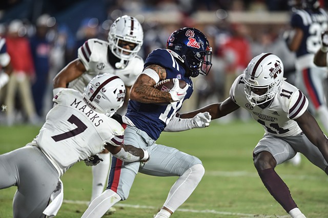 Ole Miss WR Jordan Watkins (11) avoids a tackle by RB Jo'quavious Marks (7) in the 2022 Egg Bowl at Ole Miss' Vaught-Hemingway Stadium in Oxford, Miss., Thursday, November 24, 2022.