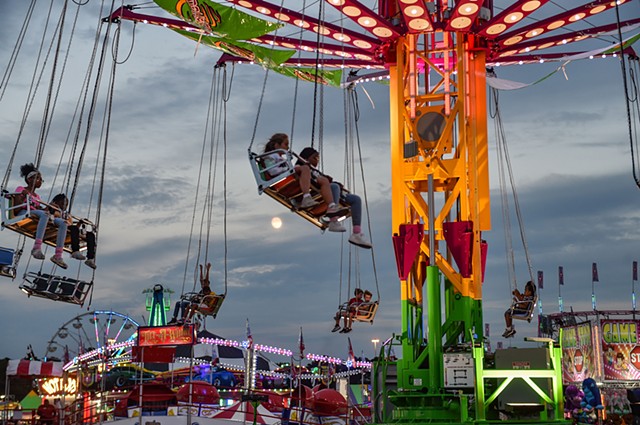 Fair attendees take a ride on the Vertigo swings at dusk at the Mississippi state fair, held at the state fairgrounds, on Friday, October 7, 2022.