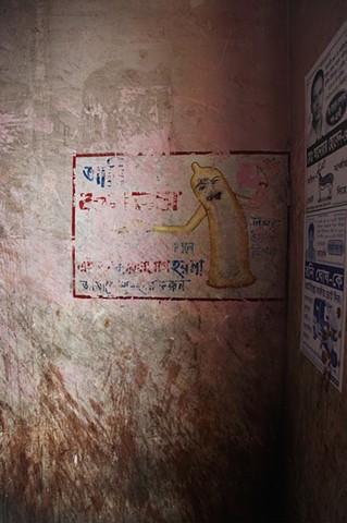 A worn sign advertises the benefits of condoms at the Rathkhola Brothel in Faridpur, Bangladesh. With an extremely high prevalence of STDs running rampant within the brothels, madams have begun educating their sex workers about protecting themselves.