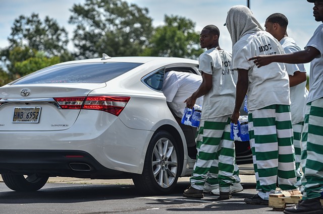 Incarcerated persons distribute water amidst Jackson's water crisis at the Salvation Army facility in Jackson, Miss., Friday, September 2, 2022.