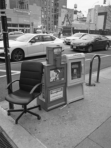 Office Chair And Newspaper Boxes 