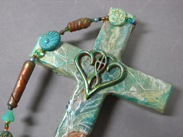 One In The Spirit_ embossed metal symbol design_ on collage wall cross