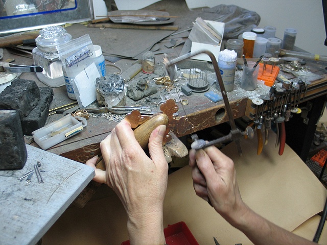 SAWING THE SPRUE REMAINS FROM CROSS